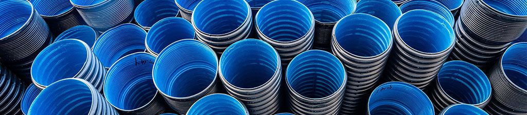 Pile of very thick blue plastic pipe