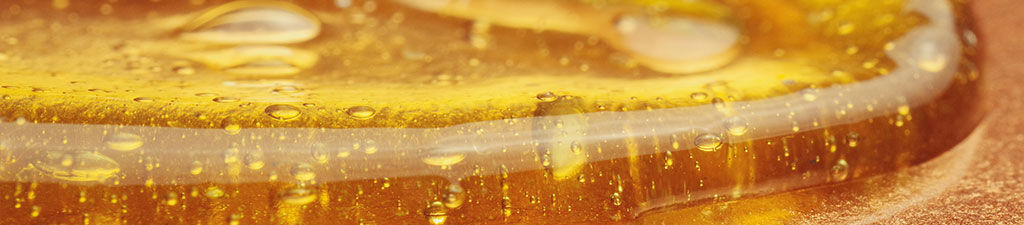 Molten gold liquid on a gold background