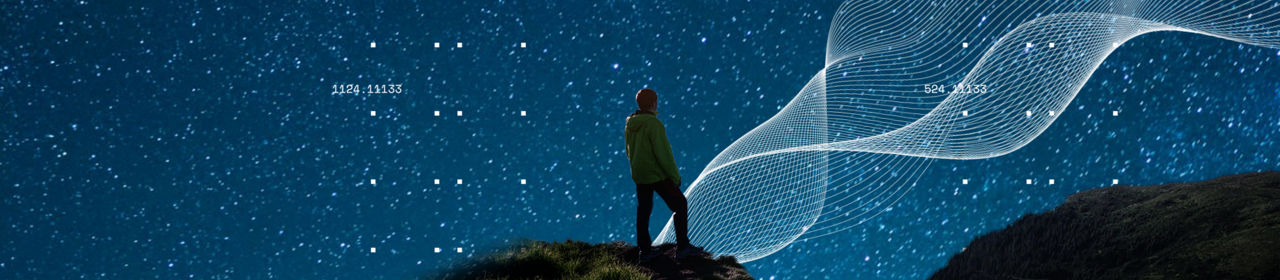 man standing on a hill and observing the stars