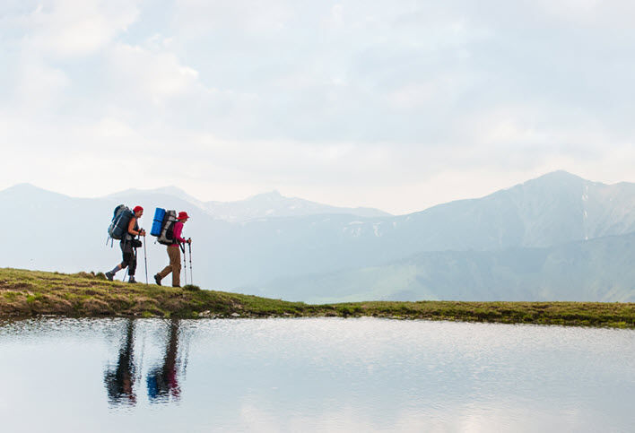 traveller walking beside a lake