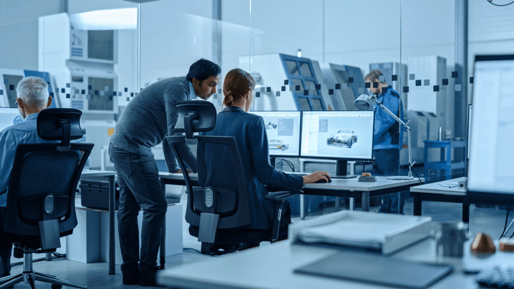 illustrative stock image of experts viewing ev software issues on a computer screen