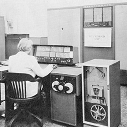 Man sitting at a desk with an old computer